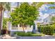 Beautiful home with mature tree in front and blue entry door with steps at 49 Ashley Ave, Charleston, SC 29401