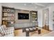 Bright living room featuring TV and custom built-in shelving at 49 Ashley Ave, Charleston, SC 29401