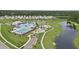 Aerial view of a community pool, playground, and pond amidst landscaped grounds and residential homes at 491 Cedarview Rd, Summerville, SC 29486