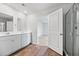 This well-lit bathroom features a double vanity, shower, and an open door to the carpeted bedroom at 491 Cedarview Rd, Summerville, SC 29486