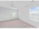 Bright bedroom features a ceiling fan, neutral carpet, two windows, and light gray walls at 491 Cedarview Rd, Summerville, SC 29486