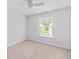 The bright bedroom features neutral carpet, a ceiling fan, one window, and light gray walls at 491 Cedarview Rd, Summerville, SC 29486