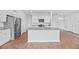 Modern kitchen featuring white cabinets, a large island with a sink, granite counters, and stainless steel appliances at 491 Cedarview Rd, Summerville, SC 29486