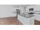 Modern kitchen with white cabinets, granite countertops, stainless steel appliances, and a large island with a sink at 491 Cedarview Rd, Summerville, SC 29486