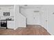 Open-concept living space features luxury vinyl flooring, a staircase, and a kitchen area with stainless steel appliances at 491 Cedarview Rd, Summerville, SC 29486