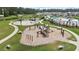 Community playground showcasing various play equipment, benches, and walkways, set in a lush green environment at 491 Cedarview Rd, Summerville, SC 29486