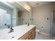 Bathroom featuring double sink vanity, shower, and soaking tub at 5023 Manor Rd, Hollywood, SC 29449