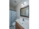 Well lit bathroom features a single sink vanity and a shower-tub combo with curtain at 5023 Manor Rd, Hollywood, SC 29449