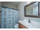 Cozy bathroom featuring a single sink vanity and shower-tub combo with nautical curtain at 5023 Manor Rd, Hollywood, SC 29449