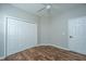 This bedroom features hardwood floors and closet with doors at 5023 Manor Rd, Hollywood, SC 29449