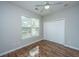This bedroom features hardwood floors, a ceiling fan, and a window that lets in plenty of natural light at 5023 Manor Rd, Hollywood, SC 29449