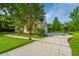 Home's driveway and grassy front yard, complemented by a basketball hoop for outdoor activities at 5023 Manor Rd, Hollywood, SC 29449