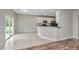 Kitchen view with granite countertop bar and sliding glass doors to backyard at 5023 Manor Rd, Hollywood, SC 29449