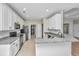 Updated kitchen boasts white cabinetry, granite counters, and a breakfast bar overlooking the living area at 5023 Manor Rd, Hollywood, SC 29449