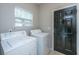 Functional laundry room includes washer, dryer, and access to the exterior at 5023 Manor Rd, Hollywood, SC 29449