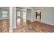 Open floor plan view showcasing laminate floors and connecting rooms at 5023 Manor Rd, Hollywood, SC 29449