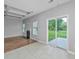 Living room with a fireplace, slider to the backyard, and windows at 5023 Manor Rd, Hollywood, SC 29449