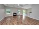 Open concept living room features laminate floors, fireplace and sliding glass doors at 5023 Manor Rd, Hollywood, SC 29449
