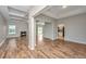 Open living room with fireplace and wood floors that seamlessly connects to the kitchen at 5023 Manor Rd, Hollywood, SC 29449