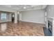 Bright and airy living room featuring laminate floors, fireplace, and a stylish front door at 5023 Manor Rd, Hollywood, SC 29449