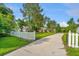 Charming homes visible from the street, featuring a white picket fence and a paved driveway at 5023 Manor Rd, Hollywood, SC 29449