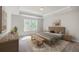 Cozy bedroom featuring a tray ceiling, a comfy bed, and warm inviting colors at 504 Sarno Way, Summerville, SC 29486