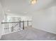 Spacious bonus room with neutral carpet, staircase with decorative wood railing at 504 Sarno Way, Summerville, SC 29486