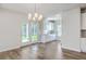 Dining area featuring modern chandelier and door to the back yard at 504 Sarno Way, Summerville, SC 29486