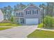 Two-story home with gray siding, double garage and well-kept front lawn at 504 Sarno Way, Summerville, SC 29486