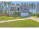 Charming two-story home with gray siding, well-maintained lawn, and attached garage at 504 Sarno Way, Summerville, SC 29486