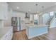 Gourmet kitchen with stainless steel appliances, island and adjacent staircase at 504 Sarno Way, Summerville, SC 29486