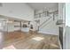 Open concept living room and kitchen featuring a breakfast bar and a staircase at 504 Sarno Way, Summerville, SC 29486