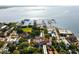 Aerial view of the property and surrounding harbor with lush landscaping and waterfront access at 55 E Bay St, Charleston, SC 29401