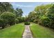 Beautiful backyard garden with symmetrical landscaping and a stone pathway at 55 E Bay St, Charleston, SC 29401