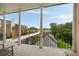 Balcony with black metal railing shows the roof line and trees beyond the building at 55 E Bay St, Charleston, SC 29401