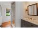 Elegant bathroom features shiplap walls, glass shower, marble vanity, and a window, providing a bright and luxurious space at 55 E Bay St, Charleston, SC 29401