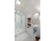 Bright bathroom features glass shower, white tile, open shelving and hexagonal tile flooring at 55 E Bay St, Charleston, SC 29401