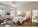 Inviting bedroom with decorative pillows, a bench at the foot of the bed and an open door to the attached bath at 55 E Bay St, Charleston, SC 29401
