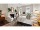 Bright bedroom features fireplace, and two chairs, complemented by ample natural light from large windows creating a serene retreat at 55 E Bay St, Charleston, SC 29401