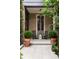 Private courtyard features potted plants, brick pavers, and seating at 55 E Bay St, Charleston, SC 29401