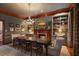 Elegant dining room featuring a fireplace, wood trim, chandelier and built-in bookshelves at 55 E Bay St, Charleston, SC 29401
