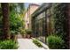 Exterior of a brick home with lush landscaping, a gate and large windows at 55 E Bay St, Charleston, SC 29401