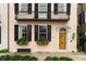 Close-up of the home's facade highlighting the charming flower boxes and architectural details around the front door at 55 E Bay St, Charleston, SC 29401