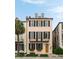 Charming pink three-story house featuring black shutters, window boxes, and a classic wooden front door at 55 E Bay St, Charleston, SC 29401