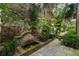 Picturesque courtyard features brick fountain, stonework, lush landscaping and stone pavers at 55 E Bay St, Charleston, SC 29401