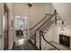 Elegant foyer with hardwood floors, staircase, and open view into the bright living room at 55 E Bay St, Charleston, SC 29401