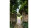 Lush garden featuring a stone walkway, manicured greenery, and charming brick walls at 55 E Bay St, Charleston, SC 29401