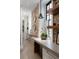 Well lit hallway with exposed brick wall, custom lighting, and decor for a stylish and inviting atmosphere at 55 E Bay St, Charleston, SC 29401