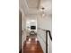 Hallway with hardwood floors that leads to a living room with neutral furniture and a TV at 55 E Bay St, Charleston, SC 29401