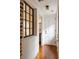 Hallway with hardwood floors and view into adjacent room and window at 55 E Bay St, Charleston, SC 29401